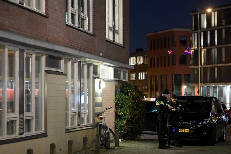 Police officers are seen in front the building where the main suspect of the shooting has been arrested in Utrecht