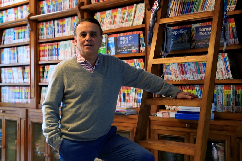 Dominique Auzias, co-founder of the Petit Fute French touristic guide book, poses during an interview with Reuters for the launching of their North Korea guide book in Paris