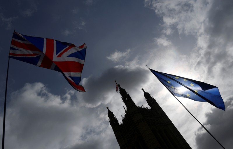 The British union flag and the EU flag are seen flying near the Houses of Parliament, in London, Britain