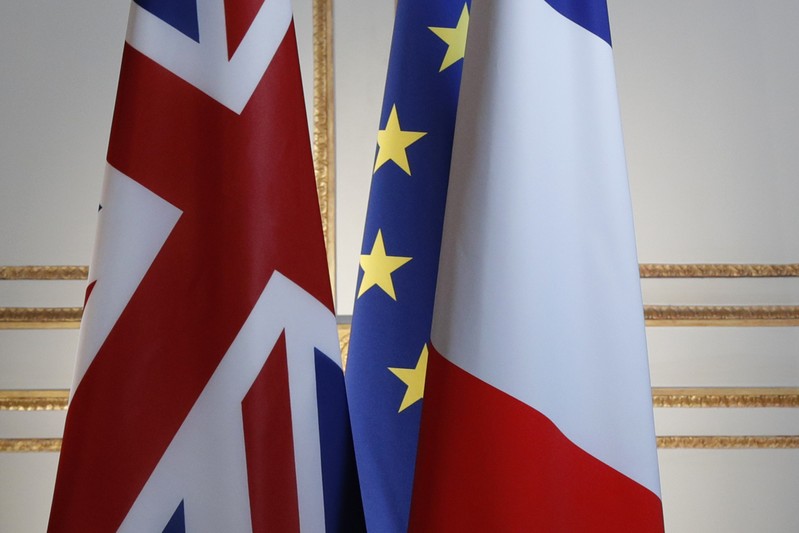 Britain, European and French flags are seen before a news conference at the Elysee Palace in Paris