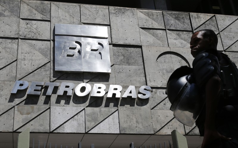 A policeman stands in front of the Petrobras headquarters during a protest in Rio de Janeiro