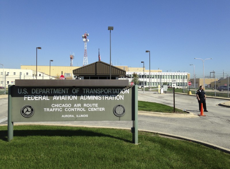 FILE PHOTO: A police officer stands guard outside the FAA air traffic control center in Aurora, Illinois
