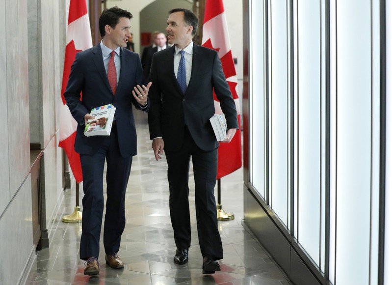 Canada's Prime Minister Justin Trudeau and Finance Minister Bill Morneau walk from Trudeau's office to the House of Commons to deliver the budget on Parliament Hill in Ottawa