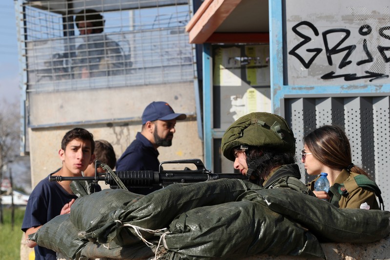 Israeli soldiers gaurd near the scene of Sunday's attack near the Jewish settlement of Ariel, in the Israeli-occupied West Bank