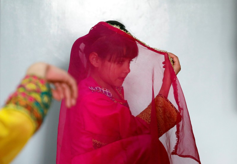 An Afghan girl practices a traditional dance at an Afghan Child Education and Care Organization center (AFCECO) in Kabul