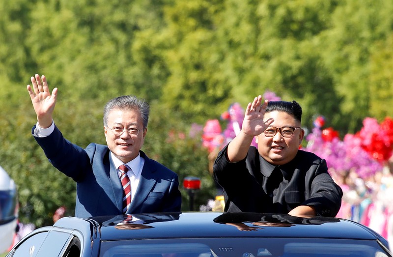 FILE PHOTO: South Korean President Moon Jae-in and North Korean leader Kim Jong Un wave during a car parade in Pyongyang