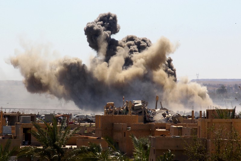 Smoke rises from the last besieged neighborhood in the village of Baghouz, Deir Al Zor province