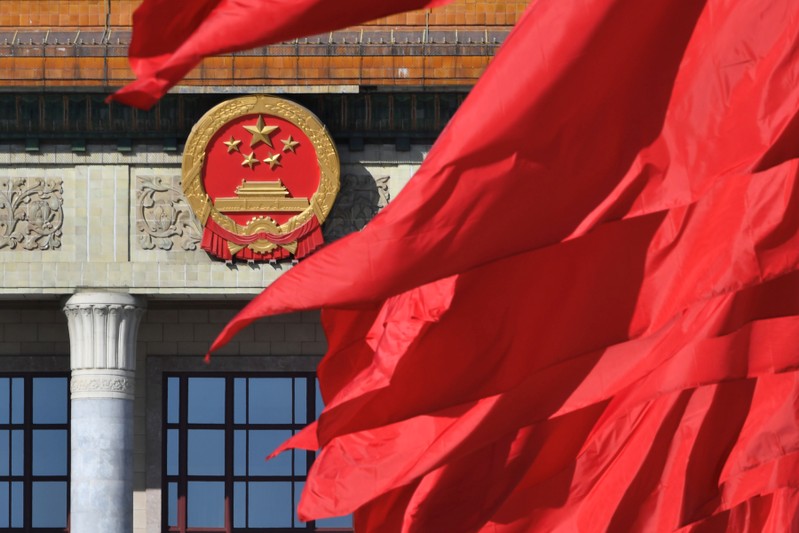 Red flags flutter outside the Great Hall of the People during the closing session of the Chinese People's Political Consultative Conference (CPPCC) in Beijing