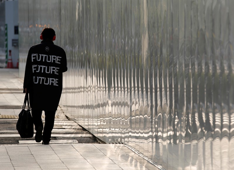 FILE PHOTO: A man makes his way in a business district in Tokyo