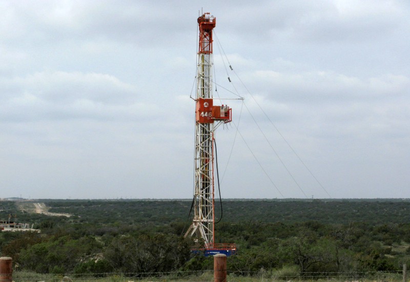 FILE PHOTO: A rig contracted by Apache Corp drills a horizontal well in a search for oil and natural gas in the Permian Basin in West Texas