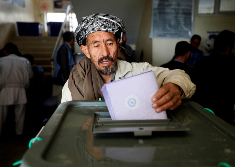 FILE PHOTO: An Afghan man casts his vote during the parliamentary election at a polling station in Kabul, Afghanistan