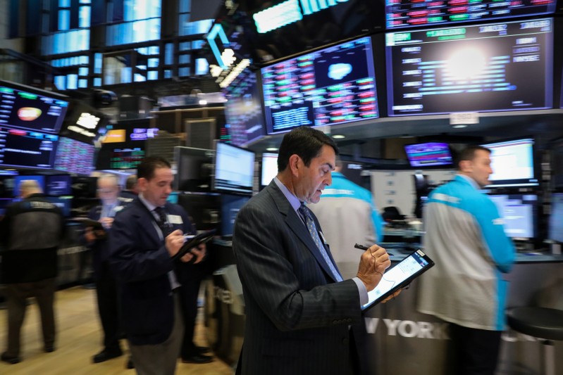 Traders work on the floor at the NYSE in New York