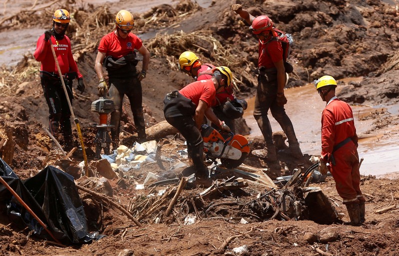 Members of a rescue team search for victims after a tailings dam owned by Brazilian mining company Vale SA collapsed, in Brumadinho
