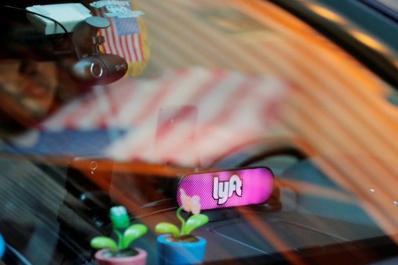 FILE PHOTO: A car with a Lyft logo in its window drives down a street as the company prepares for its upcoming IPO in New York