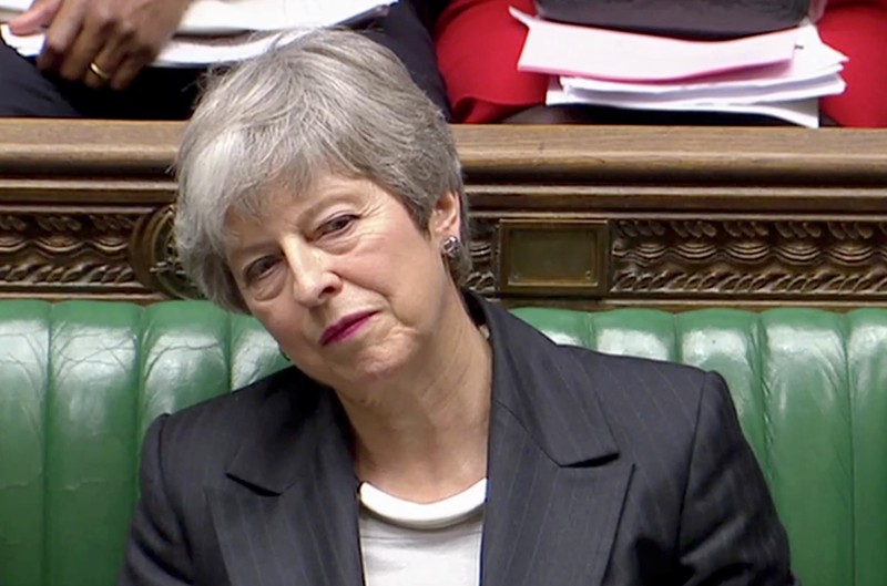 Britain's Prime Minister Theresa May listens in Parliament, in London
