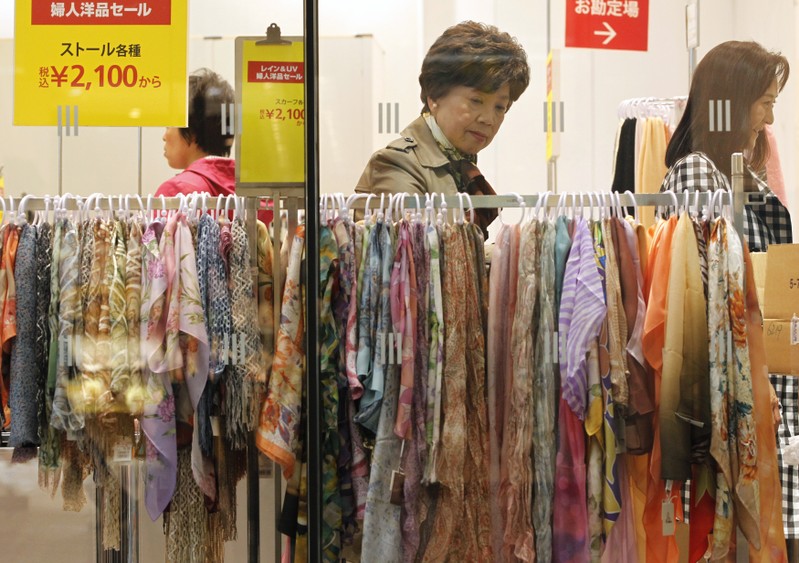 FILE PHOTO: A woman looks at scarves on sale at a department store in Tokyo