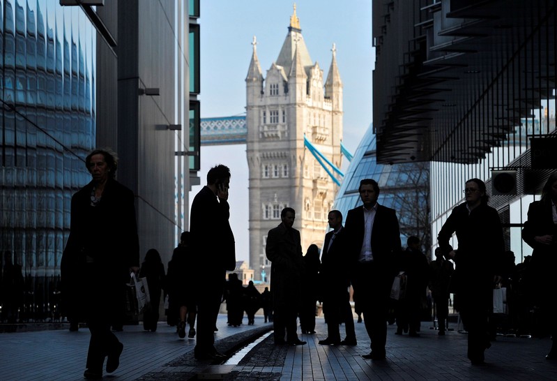 FILE PHOTO - Office workers are seen in the London Place business district near Tower Bridge in central London