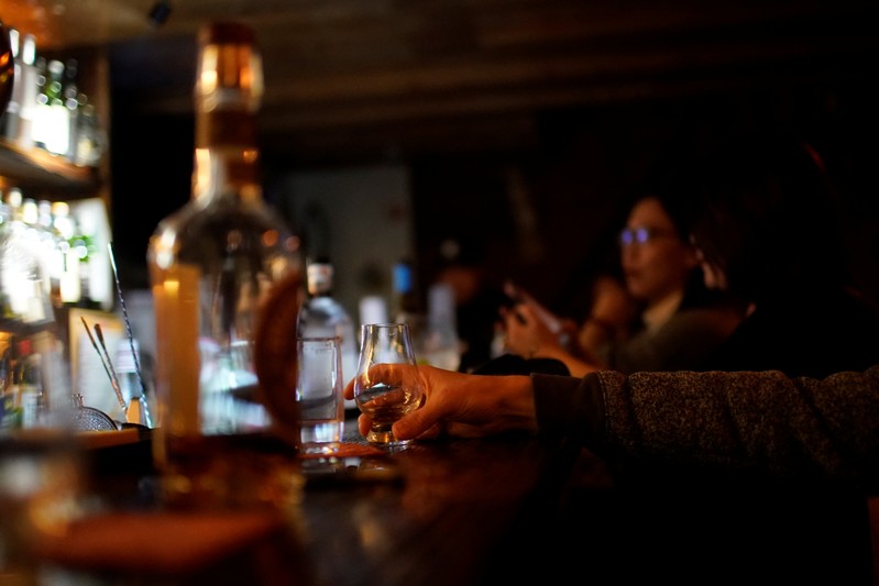A man drinks American whiskey at a bar in Shanghai