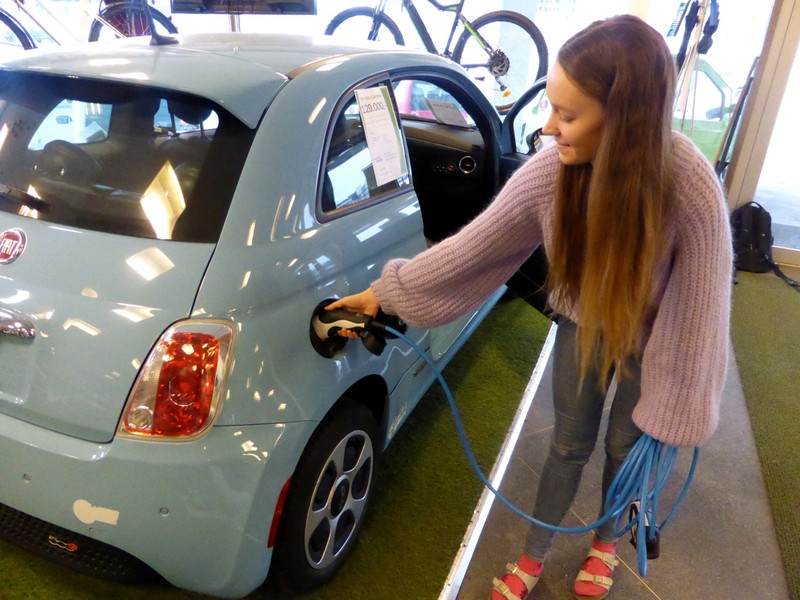 Skram of Buddy Electric car dealer company shows the charging of a second-hand Fiat 500e in Oslo