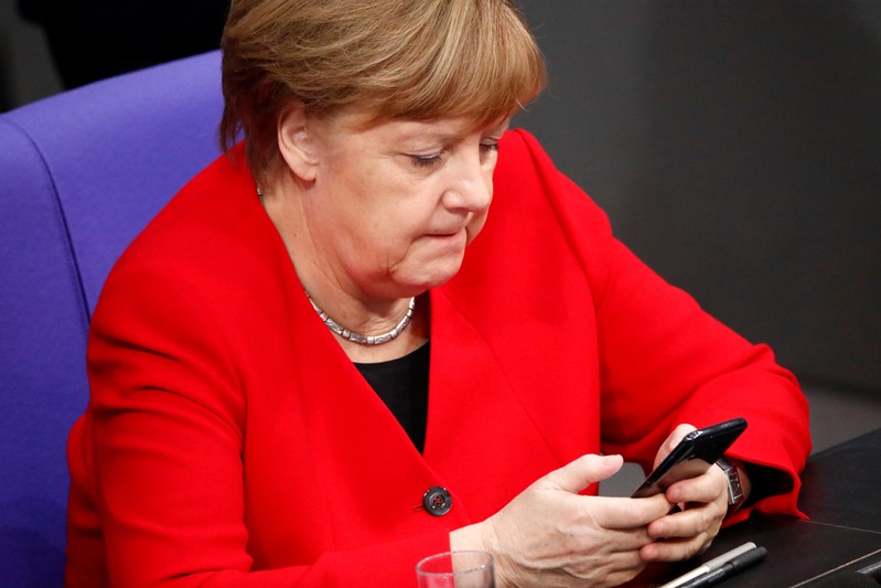 German Chancellor Merkel checks phone at Bundestag ahead of EU summit on Brexit delay in Berlin