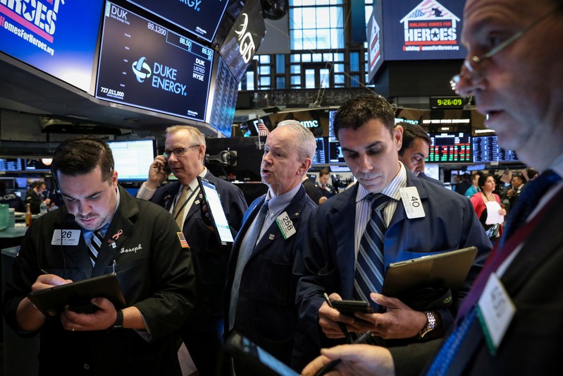 Traders work on the floor at the NYSE in New York