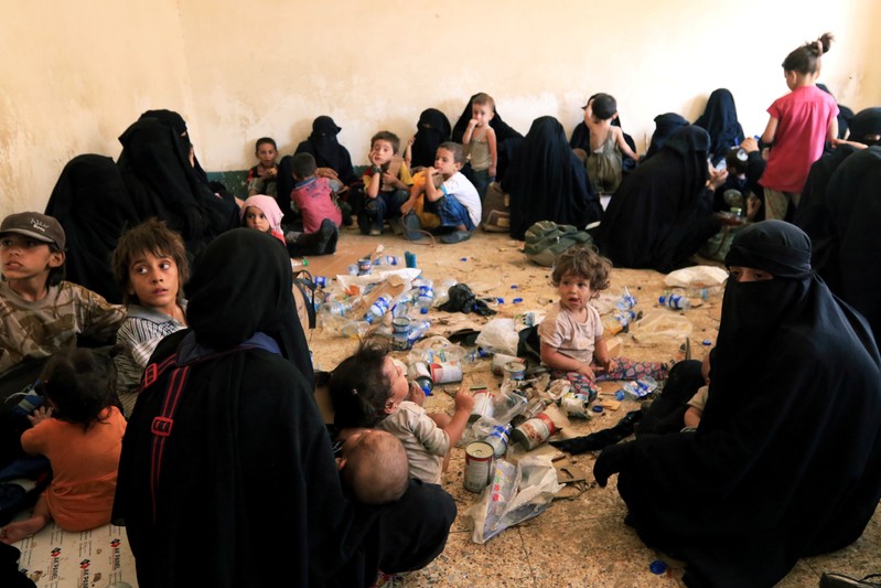 FILE PHOTO: Families and relatives of Islamic State militants are seen after they surrender themselves to the Kurdish Peshmerga forces in al-Ayadiya, northwest of Tal Afar