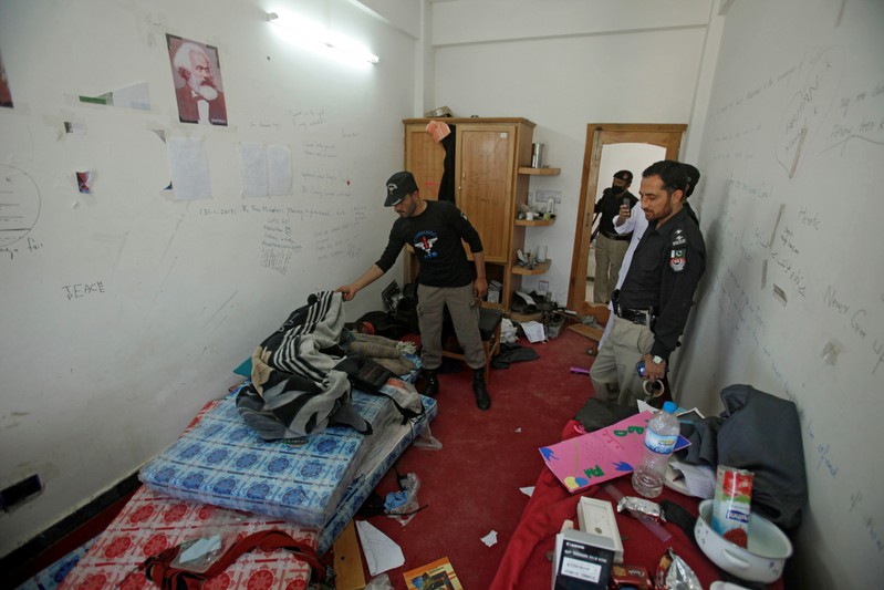 FILE PHOTO: Police search the dorm room of Mashal Khan, accused of blasphemy, who was killed by a mob at Abdul Wali Khan University in Mardan