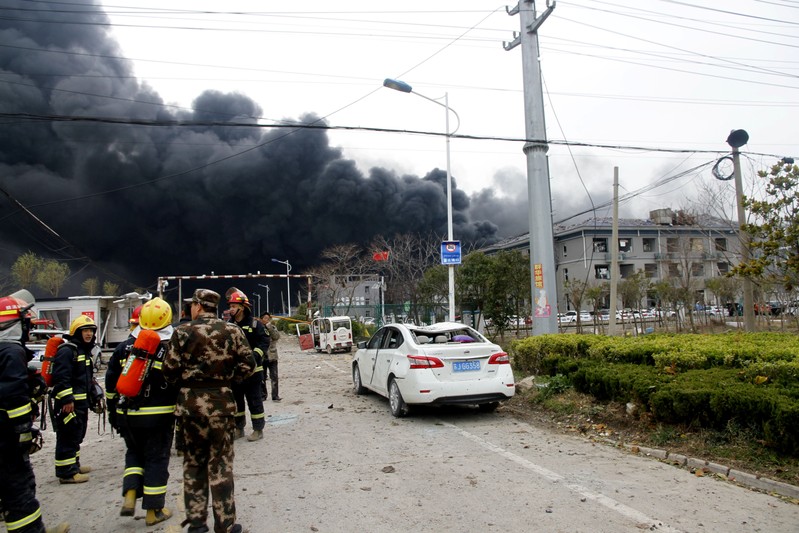 Rescue workers are seen near smoke following an explosion at a chemical industrial park in Xiangshui