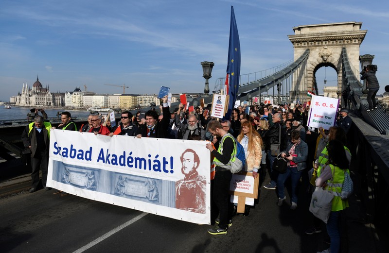 People take part in a protest against government's plans to overhaul the Hungarian Academy of Sciences, on the Chain Bridge in Budapest.