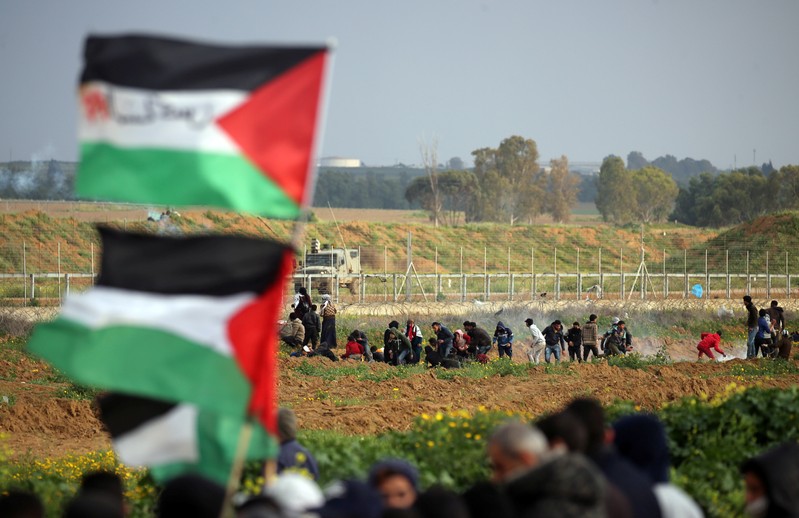 Palestinian demonstrators protest at the Israel-Gaza border fence, in the southern Gaza Strip