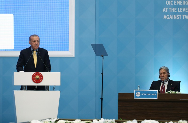 Turkish President Erdogan makes a speech as New Zealand's Foreign Minister Winston listens in Istanbul