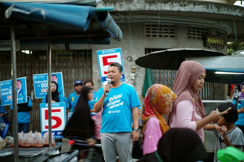 Democrat Party's candidate Anwar Salae campaigns at a market in Pattani province