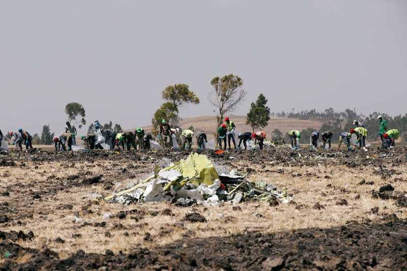 Ethiopians search for remains at the Ethiopian Airlines Flight ET 302 plane crash before a commemoration ceremony at the scene of the of the crash, near the town of Bishoftu, southeast of Addis Ababa
