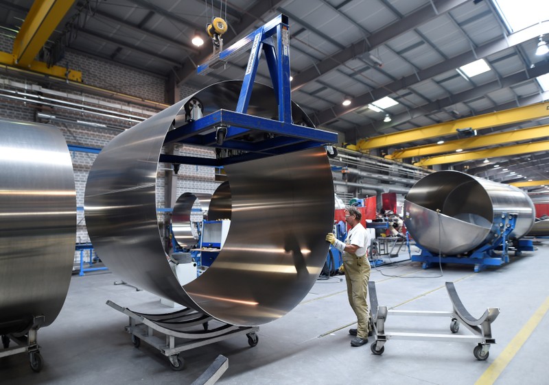 A worker at German manufacturer of silos and liquid tankers, Feldbinder Special Vehicles, moves rolls of aluminium at the company's plant in Winsen