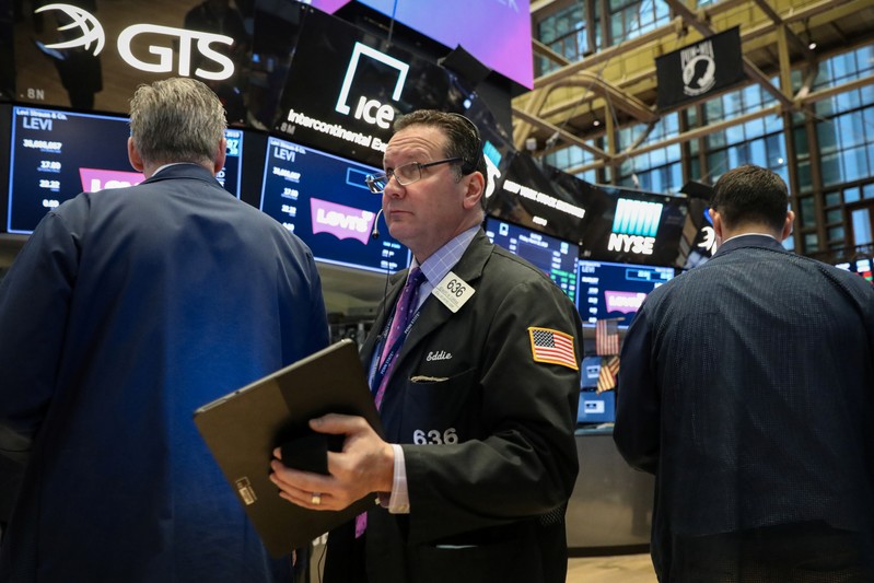 Traders work on the floor at the NYSE in New York