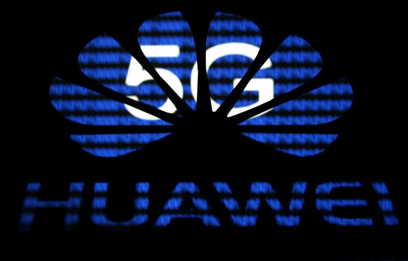 FILE PHOTO: A 3-D printed Huawei logo is seen in front of displayed 5G words in this illustration