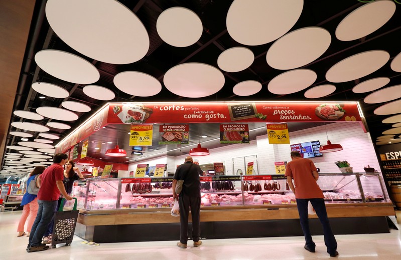 FILE PHOTO: Consumers wait to buy meat products at a Pingo Doce supermarket in Lisbon