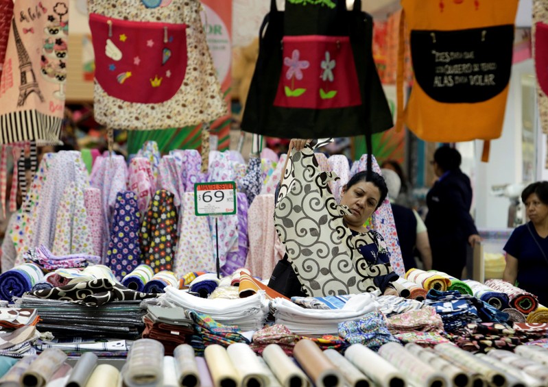 FILE PHOTO: Woman checks a curtain at a store in Mexico City