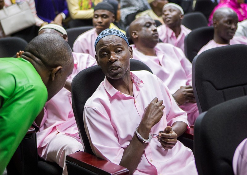 Unidentified suspects talk inside the Rwandan high court after being convicted of belonging to extremist groups including al Shabaab and Islamic State and providing them support, in Nyanza