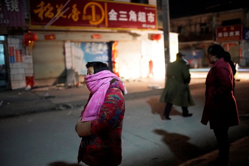 Villagers stand outside their damaged houses following an explosion at a pesticide plant owned by Tianjiayi Chemical, in Xiangshui county