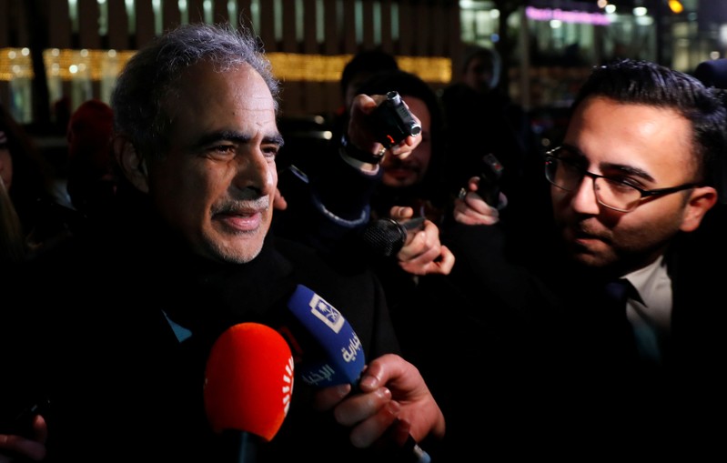 Oman's Oil Minister Mohammed bin Hamad al-Rumhy talks to journalists as he leaves the OPEC headquarters in Vienna