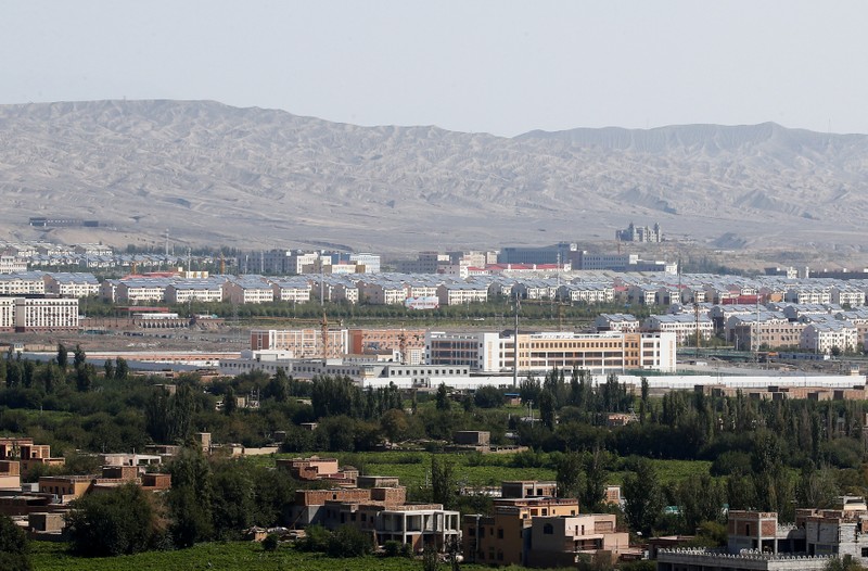 FILE PHOTO: With Xinjiang’s fabled Tianshan mountains in the background, what is officially known as a vocational skills education centre is seen in Turpan