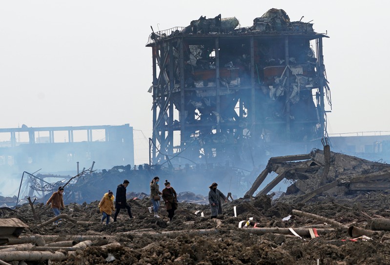Relatives look for a missing worker at the pesticide plant owned by Tianjiayi Chemical following an explosion, in Xiangshui county