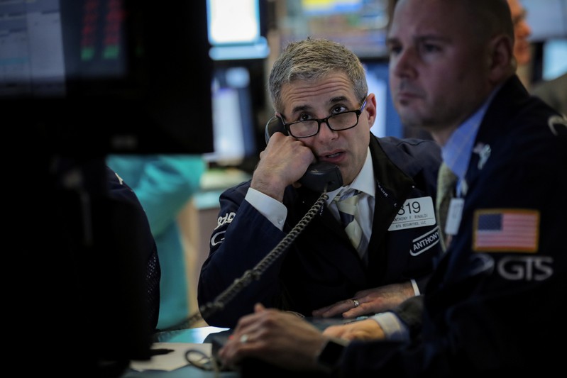 Traders work on the floor at the NYSE in New York