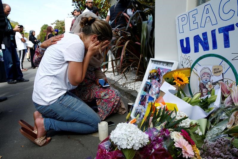 FILE PHOTO: A woman reacts at a make shift memorial outside the Al-Noor mosque in Christchurch