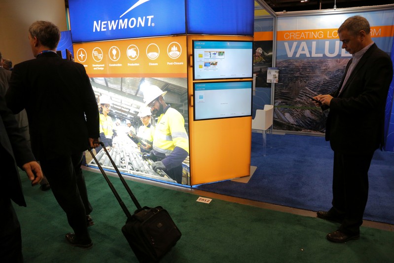 FILE PHOTO: Visitors pass the Newmont Mining Corporation booth during the PDAC convention in Toronto