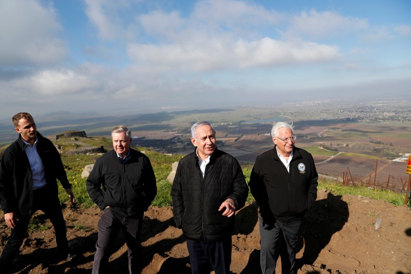 FILE PHOTO: Israeli Prime Minister Benjamin Netanyahu, U.S. Republican Senator Lindsey Graham and U.S. Ambassador to Israel David Friedman visit the border line between Israel and Syria at the Israeli-occupied Golan Heights