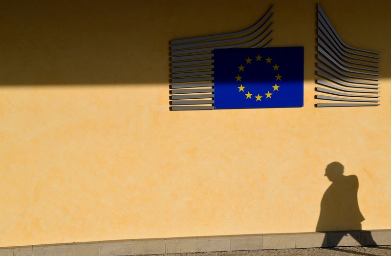 FILE PHOTO: The shadow of a worker is seen beside the EU Commission building in Brussels, Belgium