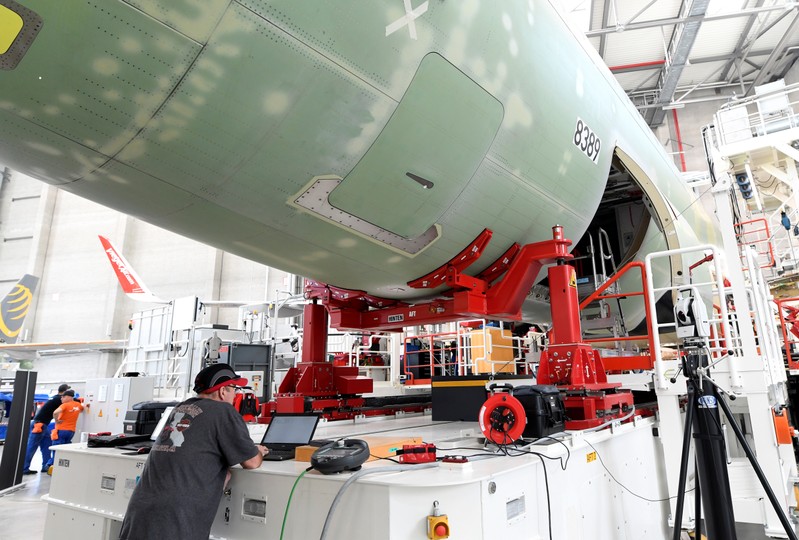 An employee of Airbus works on a computer in a new A320 production line at the Airbus plant in Hamburg