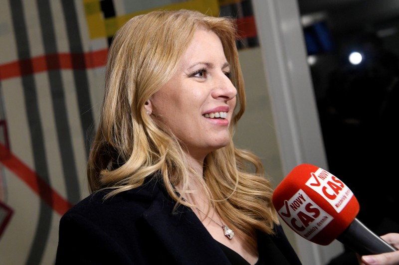 FILE PHOTO: Slovakia's presidential candidate Zuzana Caputova speaks with journalists after a televised debate with her opponent Maros Sefcovic (not pictured) ahead of an election run-off, at TV Markiza